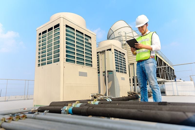 Image of technician working commercial maintenance. What Are the Benefits of Commercial HVAC Maintenance?