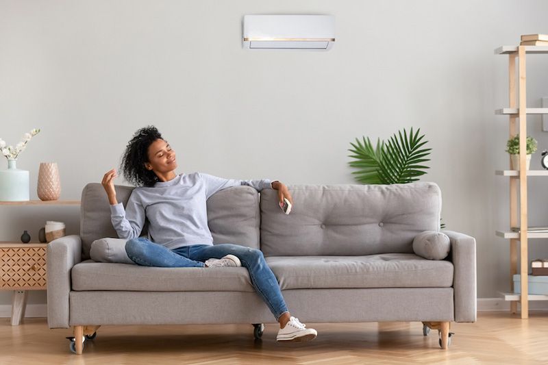 A woman relaxes on a couch. What Accessories Can Help With My Indoor Air Quality?